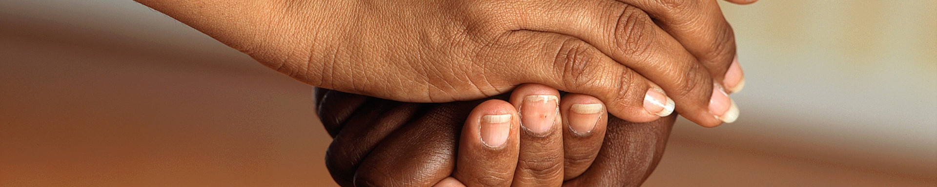 close-up of two people clasping hands